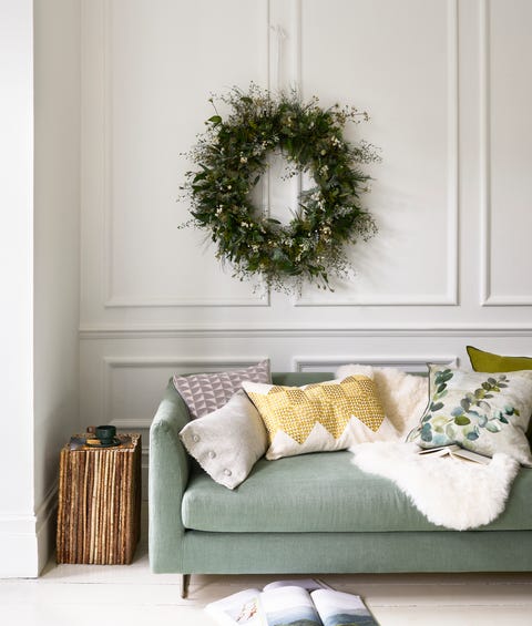 winter wonderland pale green sofa and a christmas wreath hanging abovenatural beauty bespoke super sized wreath, £250, zita elzesofa in brera moda thyme and lambusa moss, from £2,395, designers guildcushions l r oblong in marl platinum, £75m, designers guild with coveredbuttons in lunama crystal, £90m, christopher farr cloth square in larochezinc, £87m, designers guild with leather piping in silver, £36m, samuel sons geotile in chartreuse, £110, niki jones adachi celadon, £85, designersguild sheepskin rug, £80, cox  cox twig vertical column side table, £875,pinch atro city small cup, £46 habitual small plate, £24 both emma johnsonceramics book, stylist’s own