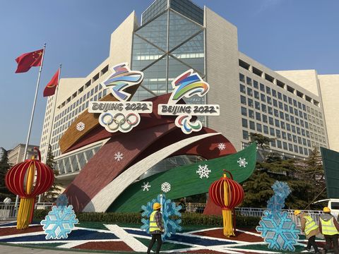 workers set up winter olympicsthemed installation in beijing
