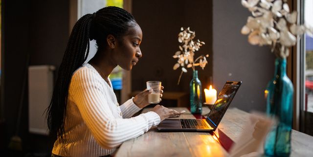 woman at coffee shop working on laptop