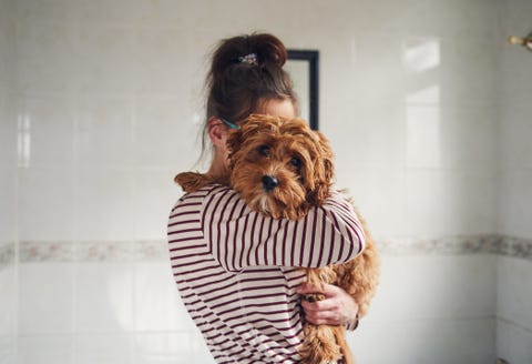 woman bathing her puppy