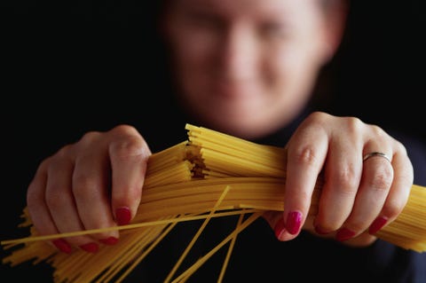 Woman Breaking Spaghetti