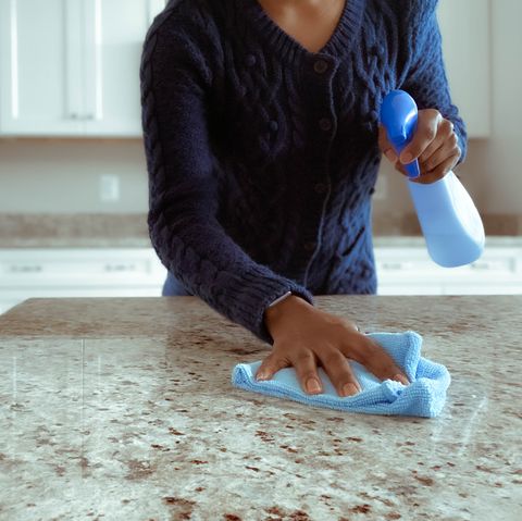 woman cleans kitchen counter