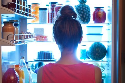 Woman Contemplating Midnight Snack late Night with Open Refrigerator