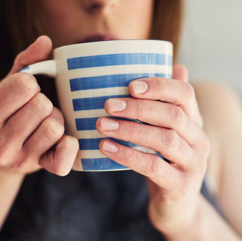 woman drinking a hot drink