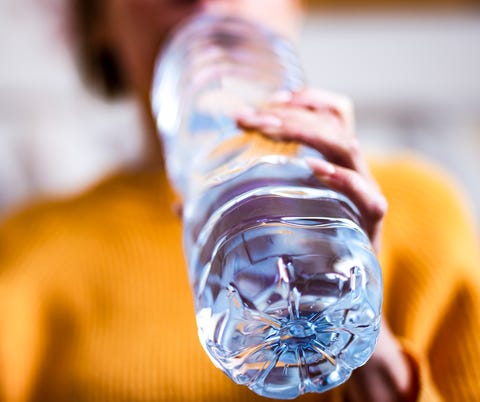 woman drinking mineral water from the bottle