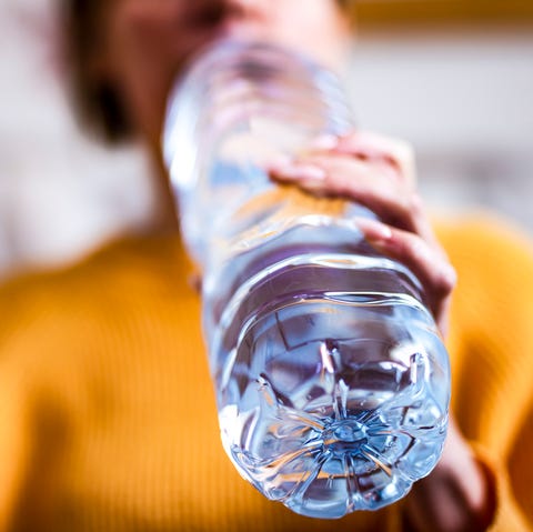 woman drinking mineral water from the bottle