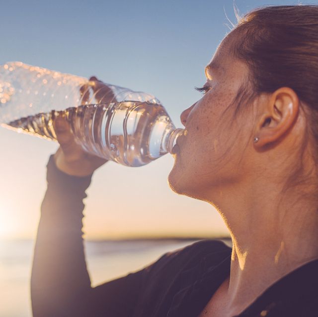 woman drinking water seaside