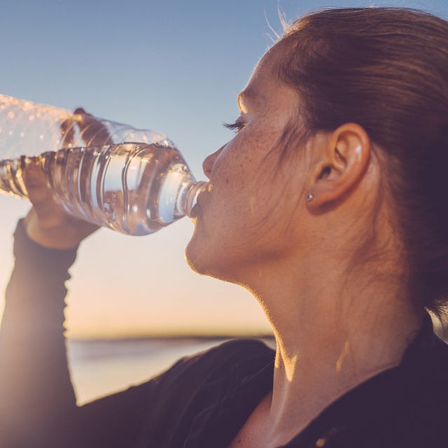 woman drinking water seaside