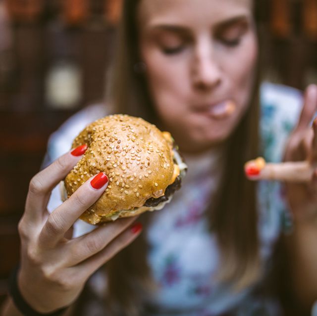 woman enjoying delicious burger
