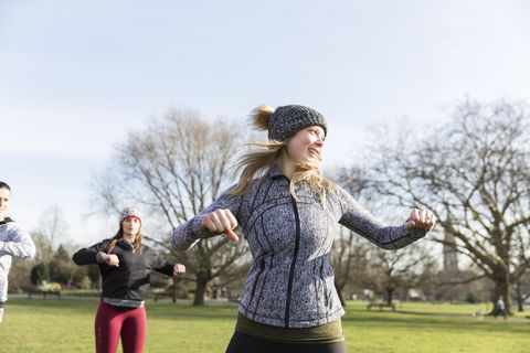 Woman exercising in sunny park