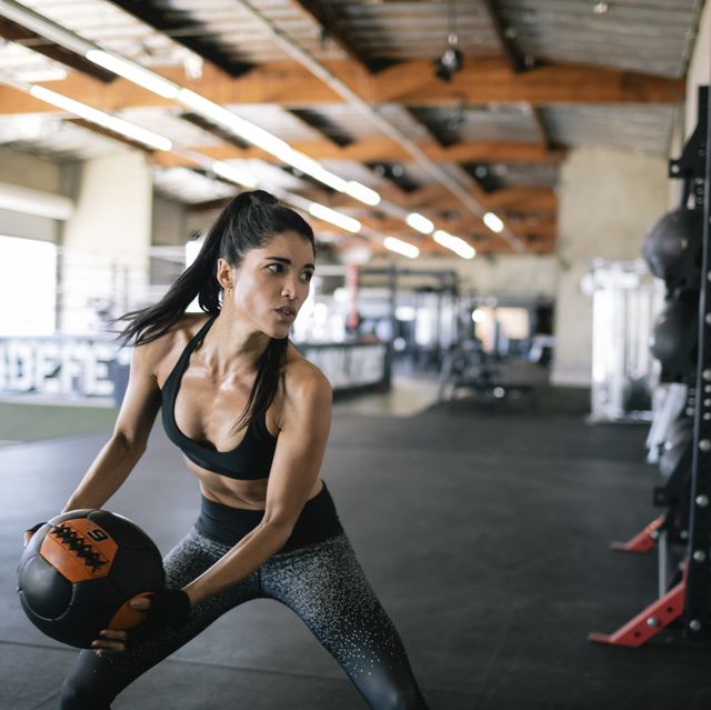 woman exercising wall ball