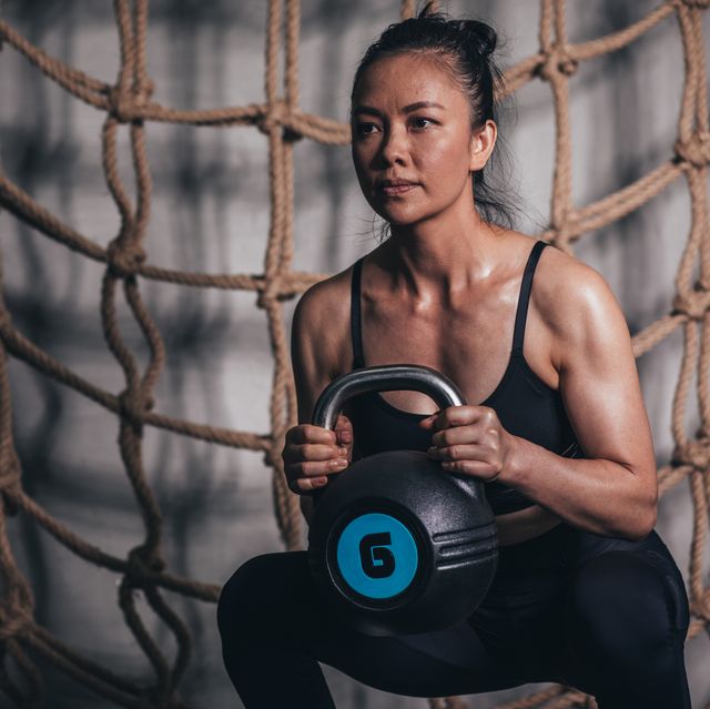 woman exercising with kettlebell