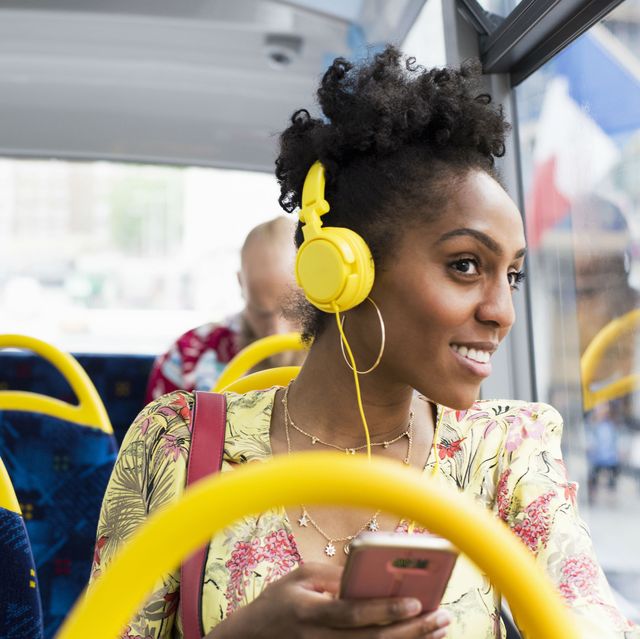 stock image – woman wearing headphones on a bus