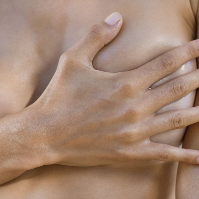 Woman hiding her breast with her hand