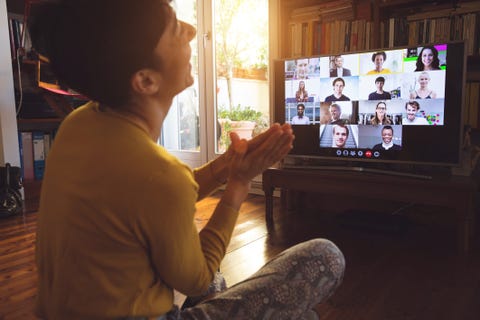 woman in front of a device screen teamworking in video conference