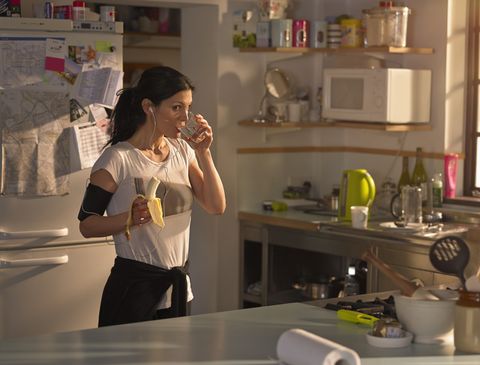Woman in the kitchen preparing for run