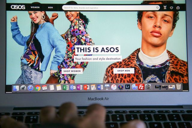 a woman is seen shopping on asos the online fashion store on a laptop