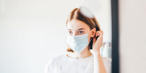 Woman looking herself in the mirror