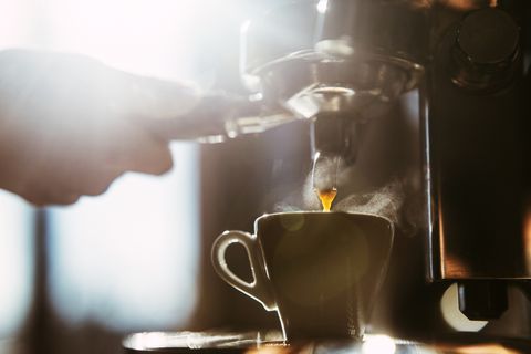 woman making espresso coffee