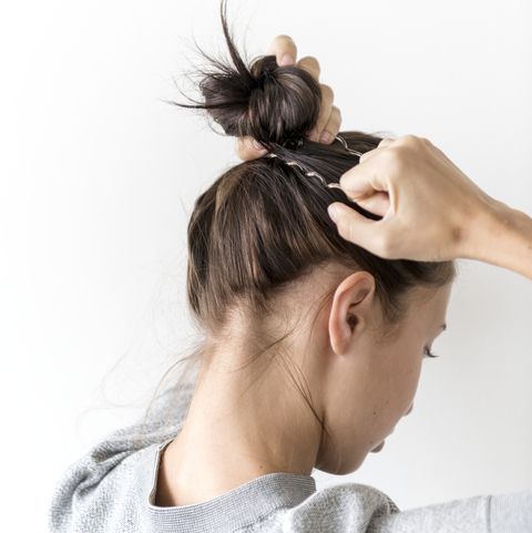 Woman making hair bun