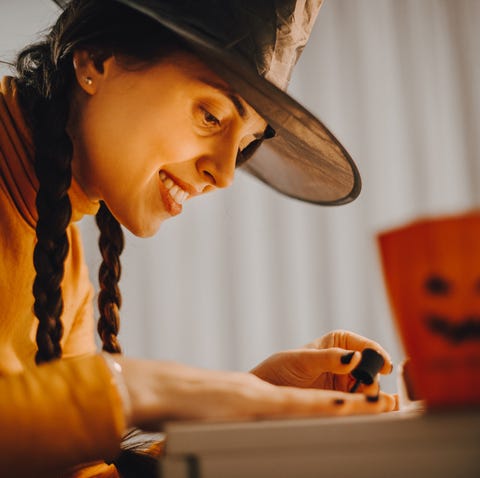 A woman paints her nails for Halloween