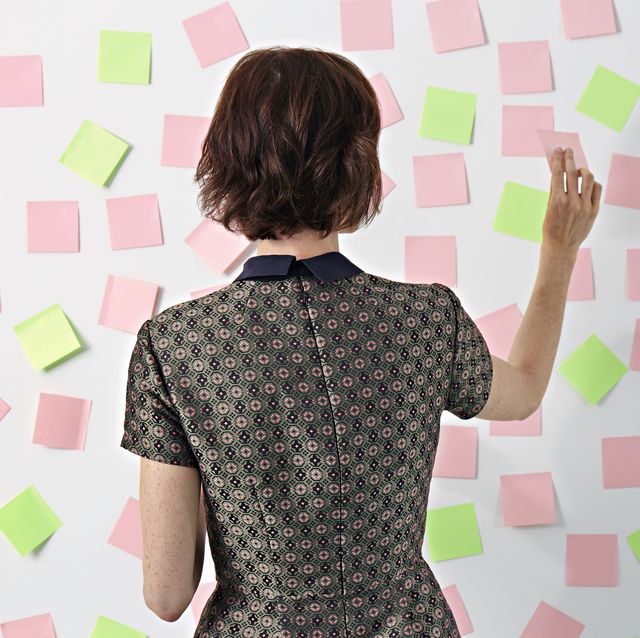 Woman placing sticky notes on board