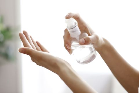 woman pouring moisturizer into hand　closeup
