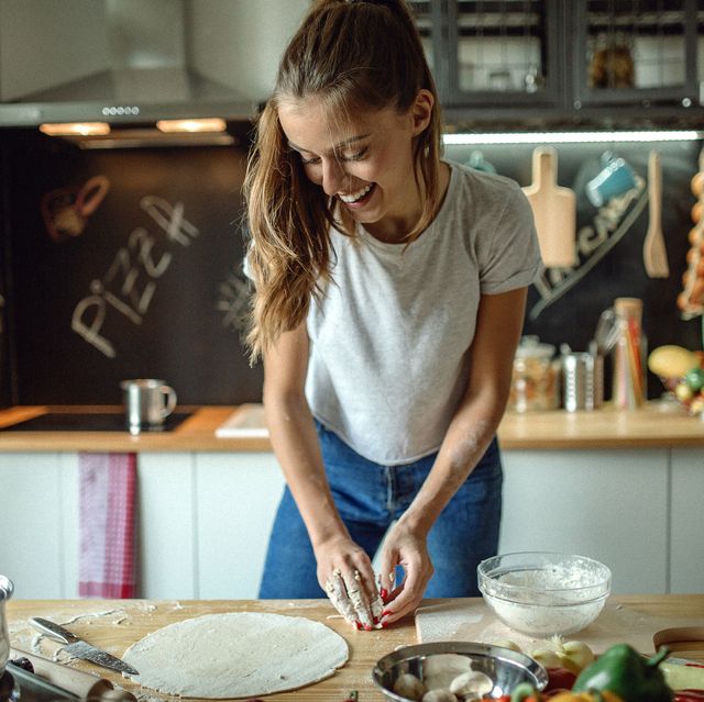 Woman preparing dought for pizza