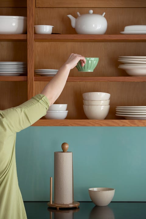 Woman Putting Away Dishes