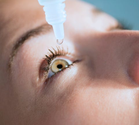 woman putting in eye drops