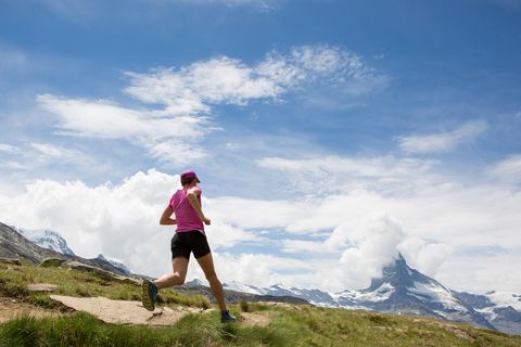 woman running on a mountain trail