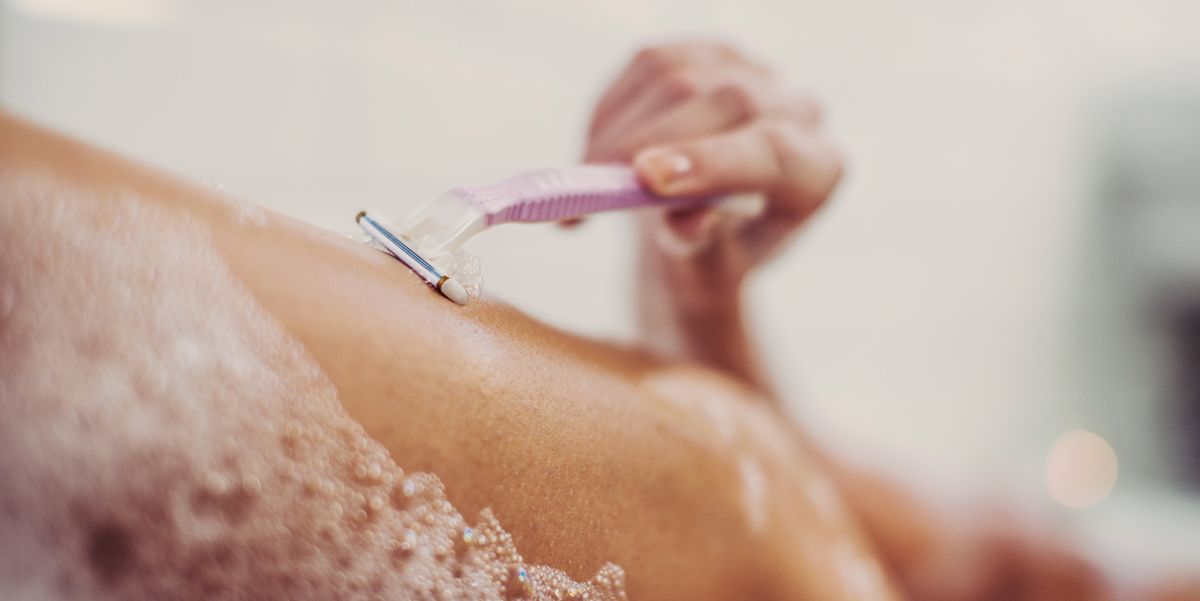 woman shaving her legs royalty free image 684639975