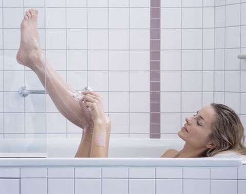 Woman Shaving Legs in Bath
