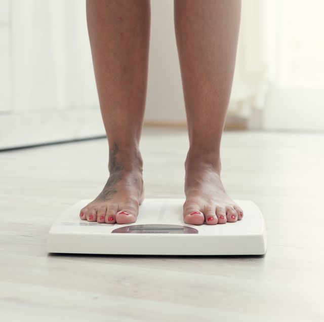 woman standing on the weight scale