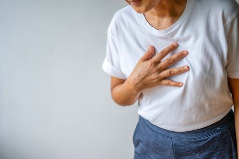 woman suffering from chest pain heart attack healthcare and medical concept