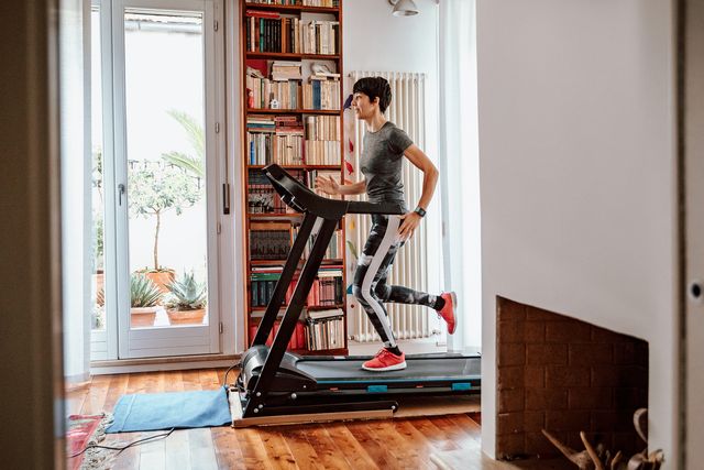 woman training on treadmill at home