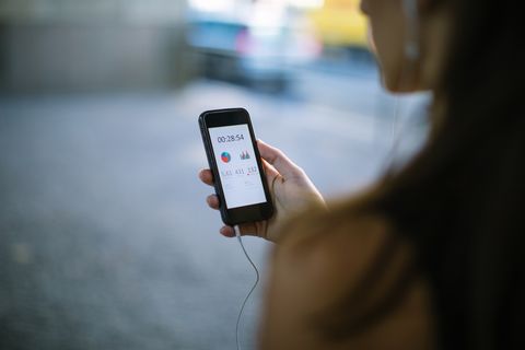 woman using fitness app on smart phone