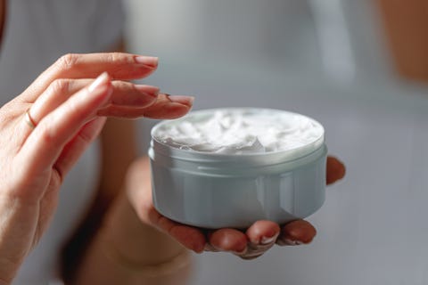 Woman using moisturizing cream for clean and soft skin woman using moisturizing cream for clean and soft skin