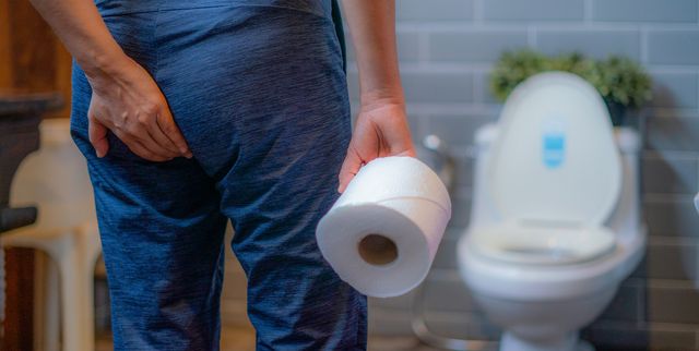woman using toilet and suffers from diarrhea and hemorrhoids after wake up at home in the morning