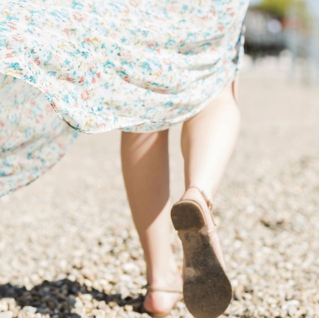 woman walking on shingle beach