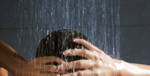 Woman washing her hair in shower woman washing her hair in shower