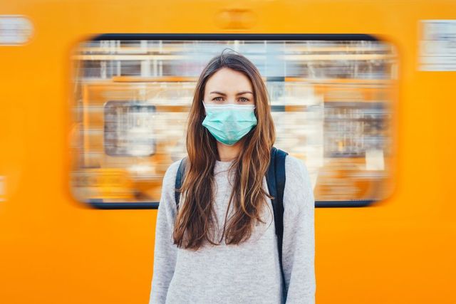 woman wearing a medical mask in a subway