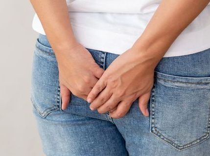 Woman wearing of jean pants from back, Female bottom and hemorrhoid symptoms from rectal cancer concept