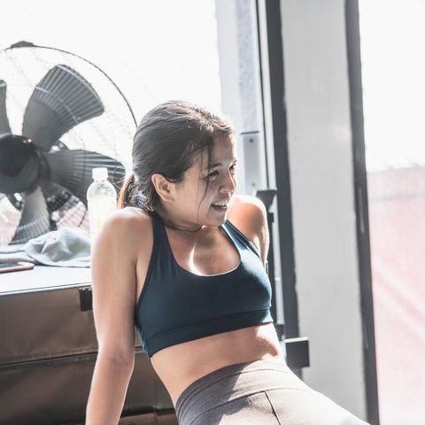 Woman wearing sports clothing, taking a break from exercise Woman wearing sports clothing, taking a break from exercise