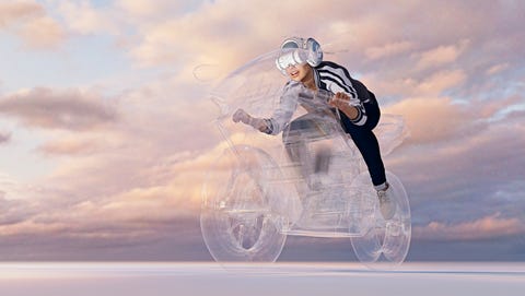 Woman wearing virtual reality helmet riding motorcycle