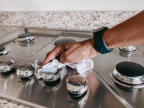 woman wipes cooktop