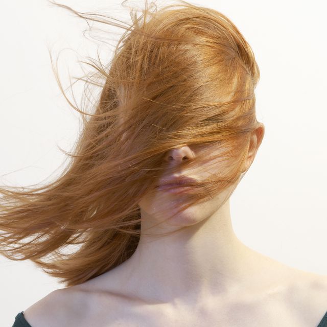 woman with hair blowing over face