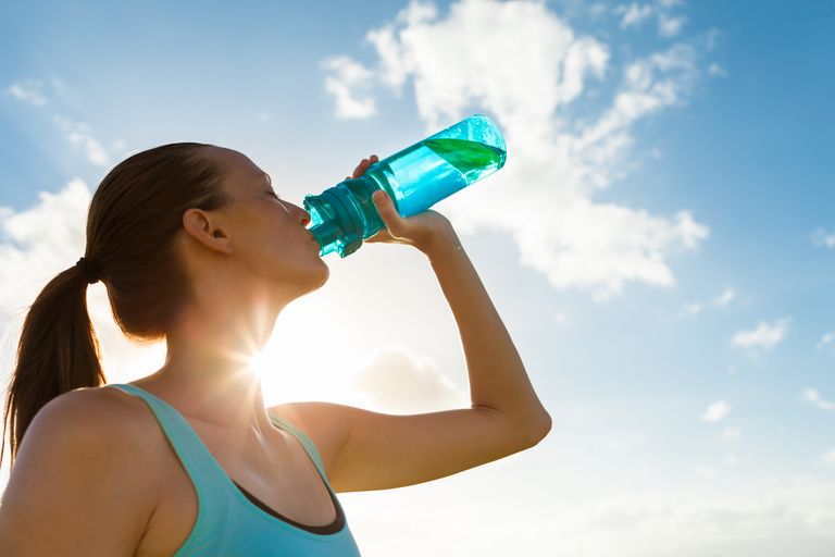 Woman working out drinking water