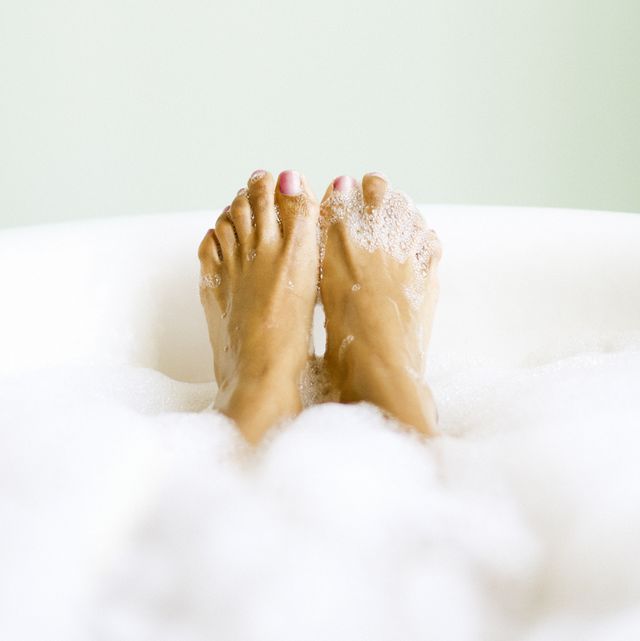 woman's feet emerging in bubble bath