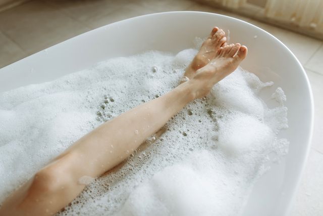 woman's feet in bubble bath